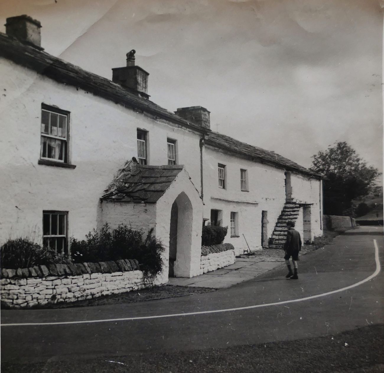 Historical photograph of white-painted cottages on a Garsdale lane