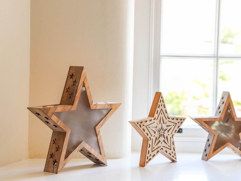 Wooden star-shaped decor pieces on a windowsill at Roger Pot in Garsdale near Sedbergh